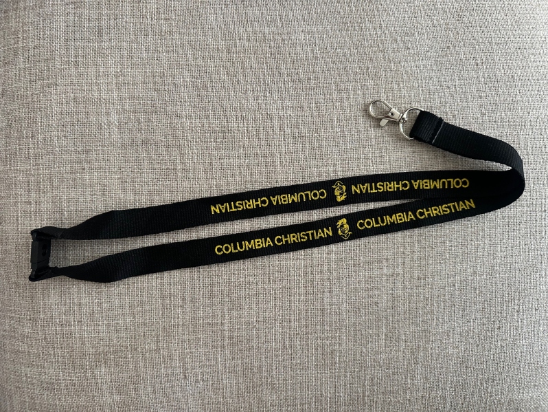 Product Description: *NEW* Columbia Christian lanyards are here!</br></br>Show off your school spirit and keep your essentials within easy reach with our stylish school-branded lanyard in black & gold.</br></br> It has a convenient swivel clip at the end and a safety break-away mechanism on the back. The material is soft and durable - perfect for daily use!</br></br>Quantities are limited so get yours today.</br></br>Shipping is not available at this time. Purchaser must be willing to pick up from the main office during business hours.</br> Lanyard